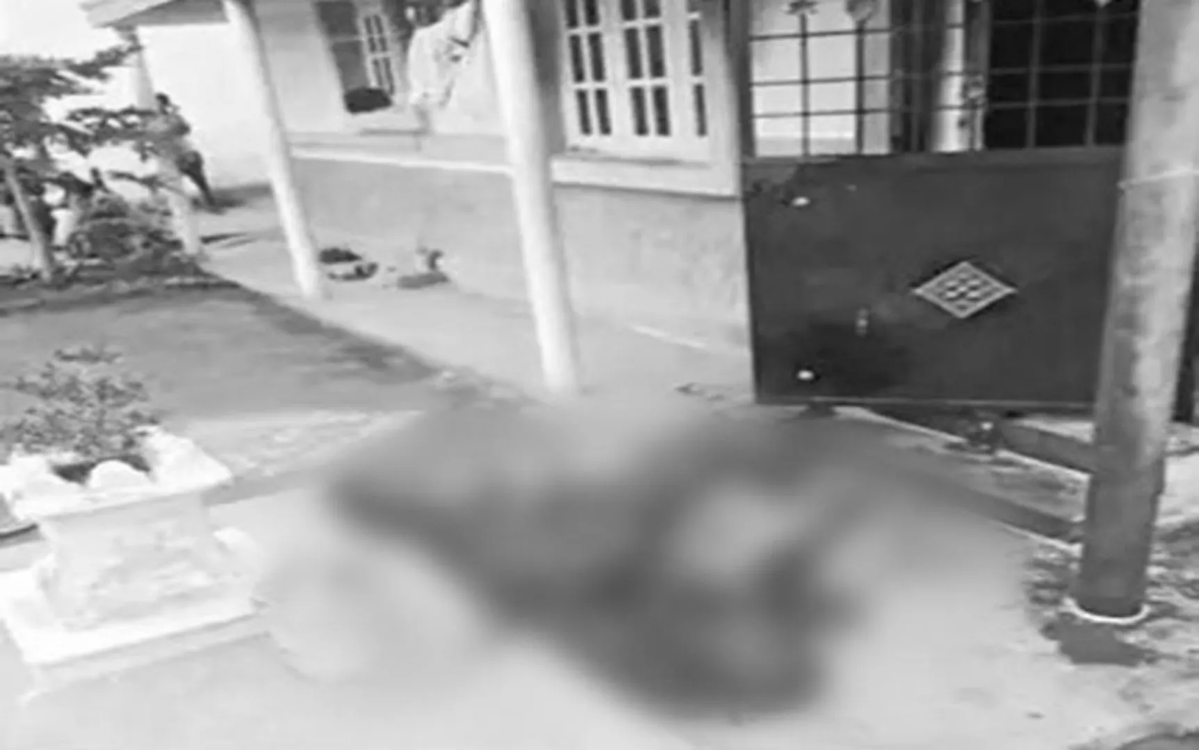body in front of house